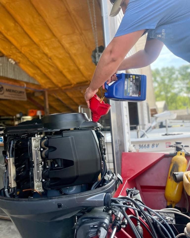 Public Water Marine technician working on an outboard